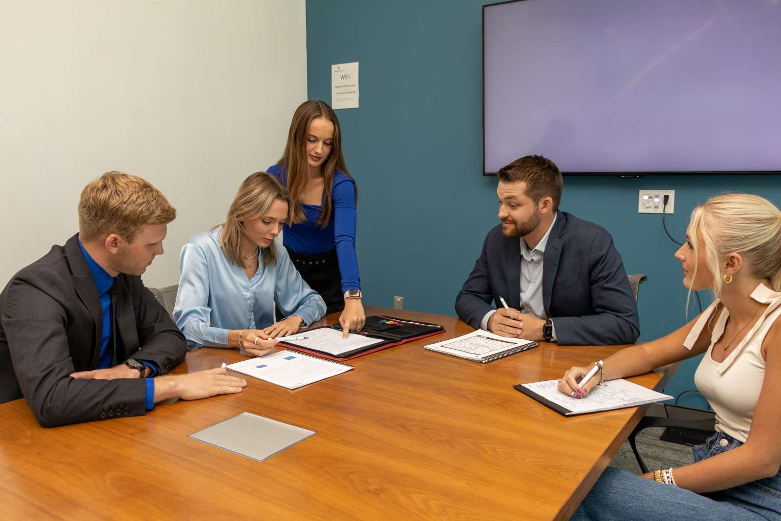 cybiz students going over papers